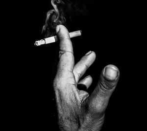 Close-up of hand holding over white background