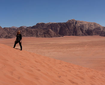 Full length of man on arid landscape against sky