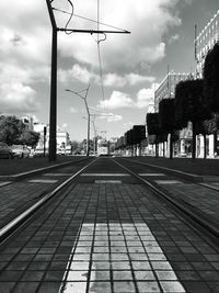 View of city street against cloudy sky