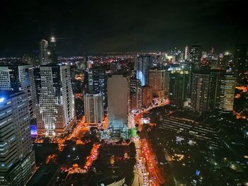 High angle view of illuminated city buildings at night