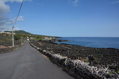 Panoramic view of road by sea against sky