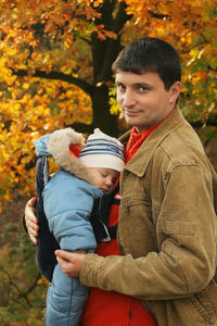 Friends standing in park during autumn