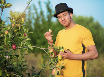 Full length of woman standing on yellow flowering plants