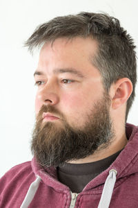 Close-up portrait of a serious young man over white background