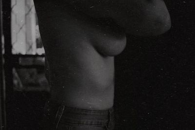 Low section of woman standing at night