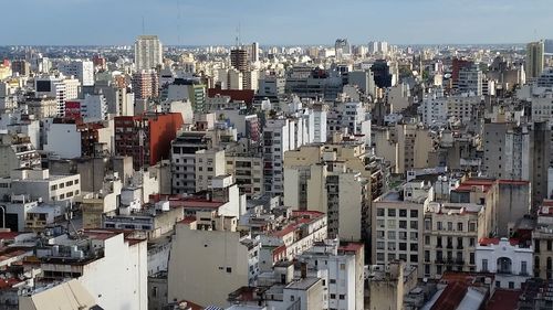 High angle view of buildings in city against sky