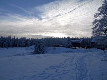 Snow covered landscape against sky