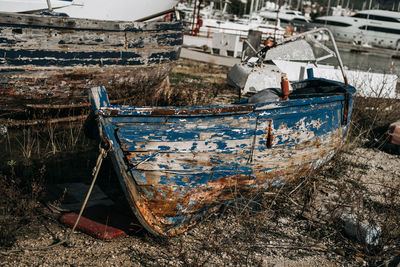 Abandoned boat moored on shore