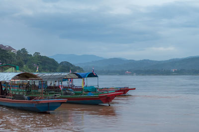 Boats moored in sea against sky