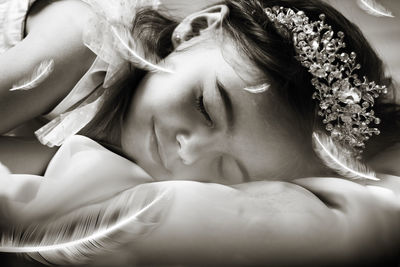 Portrait of woman lying down on bed