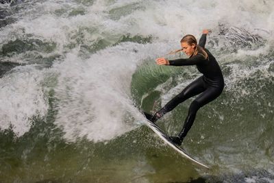 Woman surfing in sea