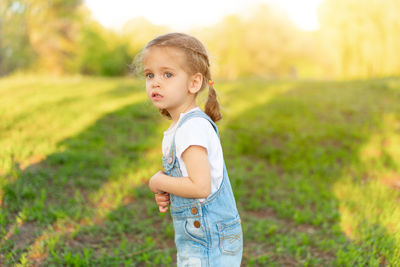 Side view of girl standing in park