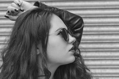 Close-up of beautiful young woman wearing sunglasses