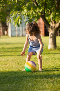 Girl playing with ball on grass