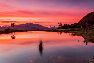 Scenic view of lake against romantic sky at sunset