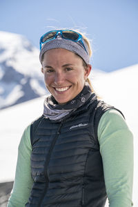Portrait of smiling female mountaineer with mt. baker in the background
