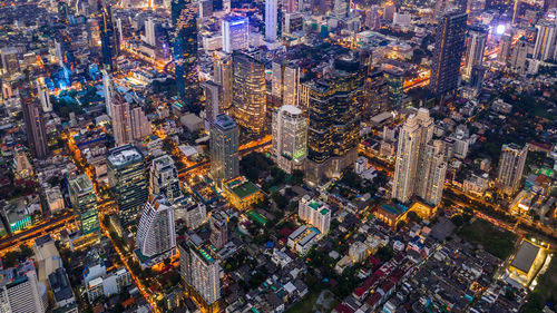 High angle view of city lit up at night