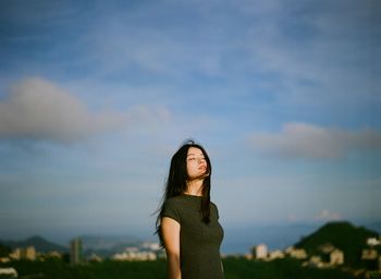 Silhouette of woman standing against sky