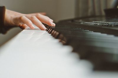 Midsection of person playing piano