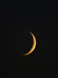 Low angle view of half moon against sky at night