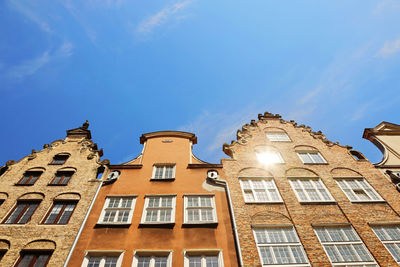 Low angle view of illuminated building against blue sky