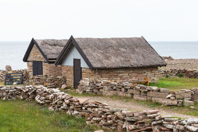 House by sea against clear sky