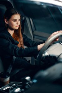 Smiling woman sitting in car