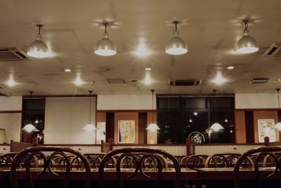 Illuminated pendant lights hanging from ceiling in restaurant