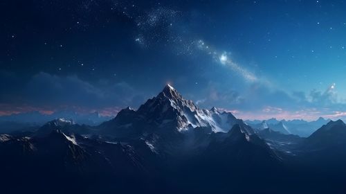 Scenic view of snowcapped mountains against sky at night