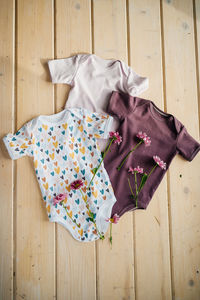 High angle view of clothes hanging on hardwood floor