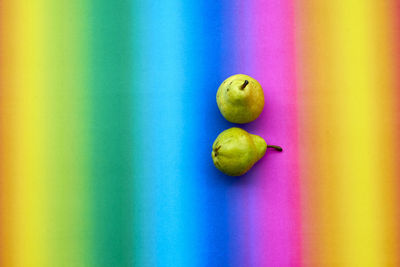 Close-up of pears over colored background