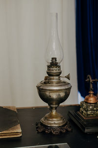 Old kerosene lamp on a rustic table. vintage writing desk