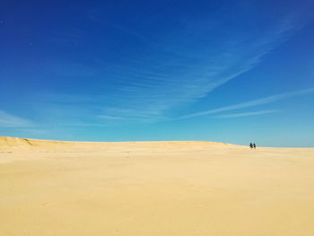 Scenic view of desert against blue sky