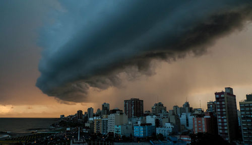 Aerial view of cityscape against dramatic sky