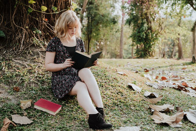 Full length of woman holding mobile phone