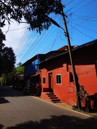 Houses by road against sky