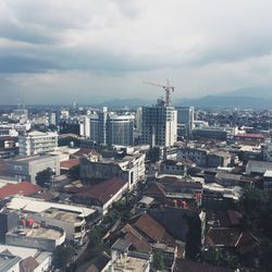 High angle view of buildings in town against sky