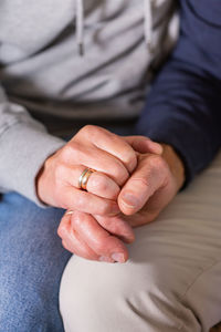 Senior married couple holding hands together. family, help, elderly care and support concept