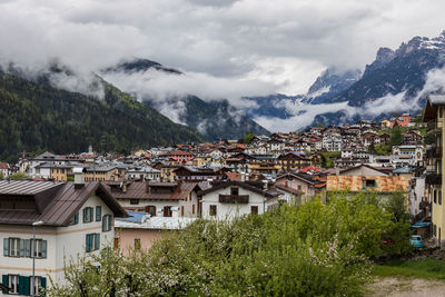 Townscape by mountains against sky