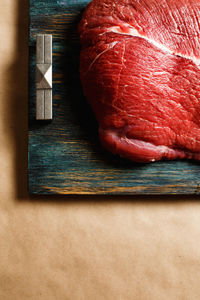 Top view of beef raw meat on wooden tray with copy space