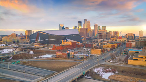 High angle view of road by buildings against sky during sunset