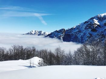 Scenic view of snow covered mountains against sky