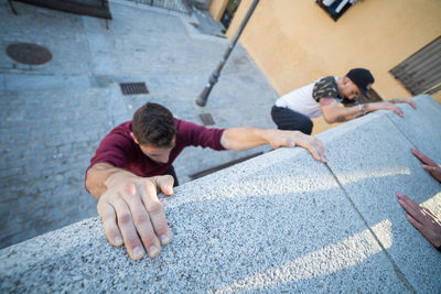 High angle view of men and man on sidewalk in city