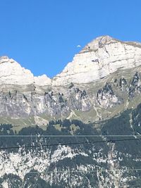 Scenic view of mountains against clear blue sky