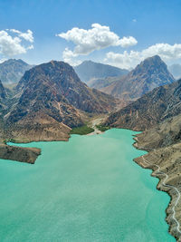 Scenic view of lake and mountains against sky