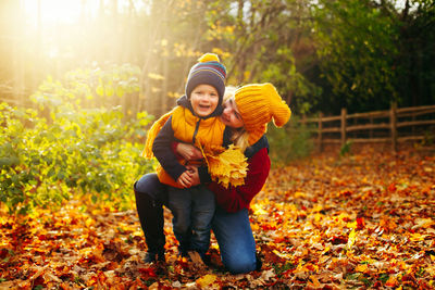 Smiling woman and son during autumn