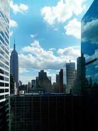 Modern buildings against cloudy sky