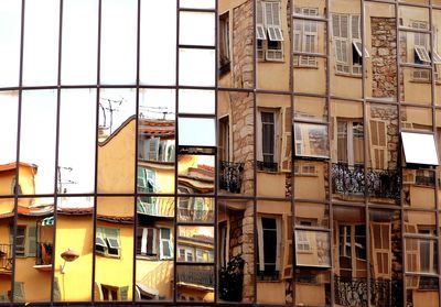 Full frame shot of modern building with reflections