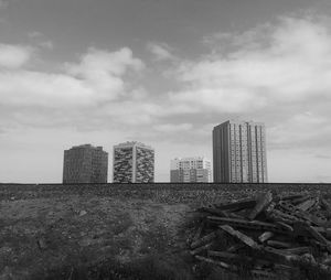 Skyscrapers against cloudy sky