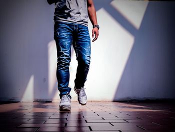 Low section of man standing on floor at home